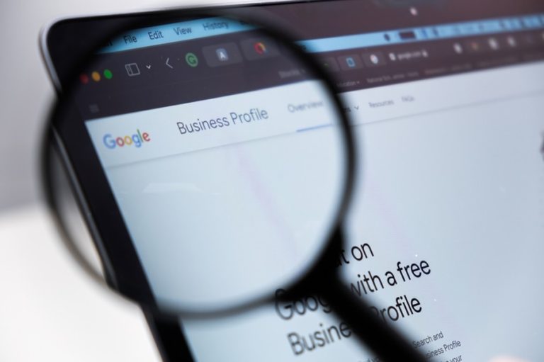 Google Business Profile seen on a laptop through a magnifying glass